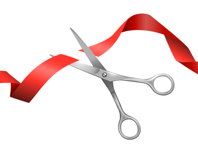 Realistic presentational composition consisting from metallic scissors cutting flying red silk ribbon on white background vector illustration